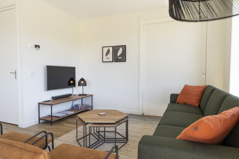 Gemuetliche Sitzecke im Ferienhaus 1 in De Dennen Texel, ideal zum Entspannen nach einem Tag voller Entdeckungen.