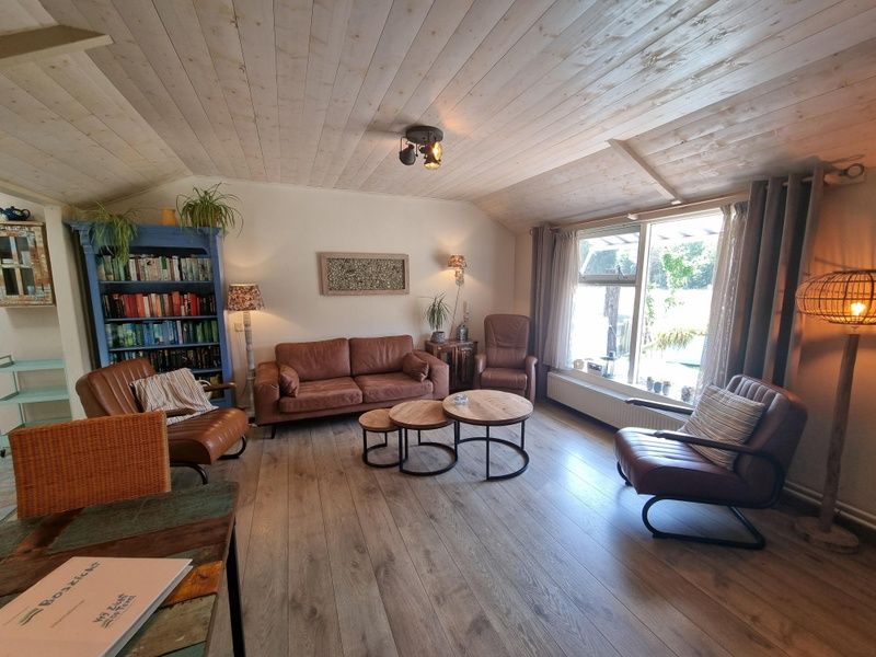 Gezellige woonkamer van Boszicht vakantiehuis in De Dennen, Texel met leren banken.