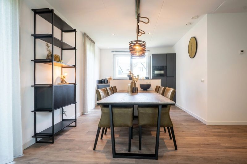 Dining room in Holiday Park De Koorn-aar Villa, De Dennen, Texel with modern furnishings.