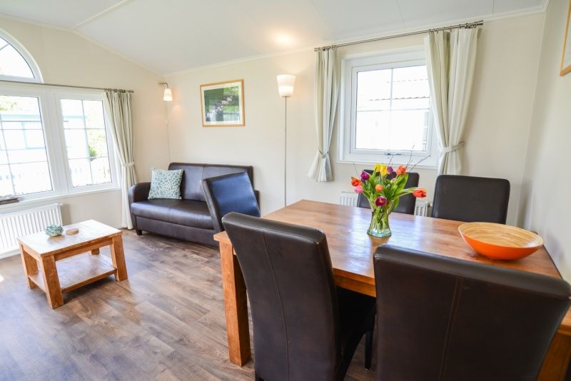Cozy living room in Holiday Park De Koorn-aar Type F, Texel, with comfortable sitting area and dining area.