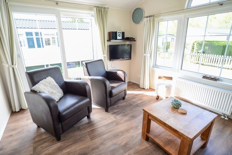 Bright living room with large windows in Holiday Park De Koorn-aar Type F, De Dennen, Texel.