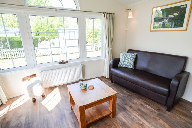 Modern living room overlooking the garden in Holiday Park De Koorn-aar Type F, Texel.