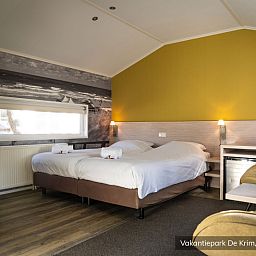 Komfortables Schlafzimmer in einem luxurioesen 2-Personen-Hotel-Chalet, De Cocksdorp, Texel, ideal fuer einen entspannten Aufenthalt.