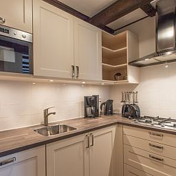 Modern kitchen in Type T-3 vacation home, De Cocksdorp, Texel, with built-in appliances.