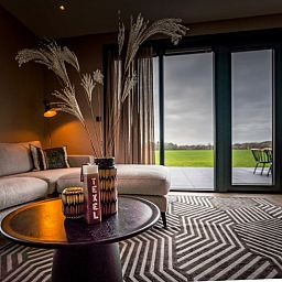 Cozy interior of 6 person vacation home in De Cocksdorp Texel overlooking terrace.