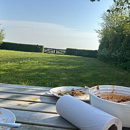 Outdoor dining overlooking the garden at Holiday home in De Cocksdorp, Texel, Wadden Islands.