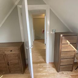 Cozy indoor space with wooden furniture in Holiday home in De Cocksdorp, Texel, Wadden Islands.