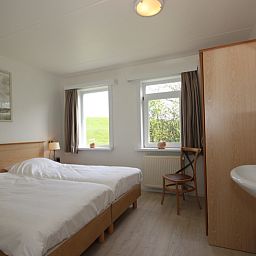 Slaapkamer met twee bedden in Bungalow De Witte Hoek 6 Pers., De Cocksdorp, Texel, lichte ruimte met uitzicht.