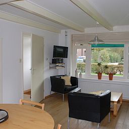 Cozy living room in Kikkertstraat 067, De Cocksdorp, Texel, with comfortable seating area.