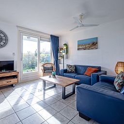 Lichte leefruimte in Vakantiehuis Slufterduin 52a, De Cocksdorp, Texel met uitzicht op de tuin.