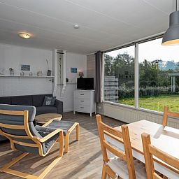 Cozy sitting area in Bungalow Tamarisk 190, De Cocksdorp, Texel, overlooking the garden.