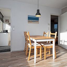 Dining area in Bungalow Tamarisk 190, a vacation home on Texel, with access to the kitchen.