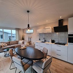 Stylish interior of Chalet Bregkoog 119 with open kitchen in De Koog, Texel, Wadden Islands.