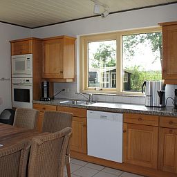 Kitchen of Landhuis Landleven No. 81, vacation home in De Koog, Texel with modern amenities and dining area.