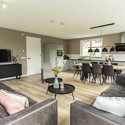 Cozy living space in Villa 17, De Koog, Texel with modern furniture and dining area for a relaxing vacation home experience.