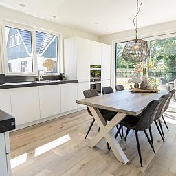 Spacious kitchen in Villa 35a, De Koog, Texel overlooking the garden.
