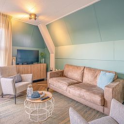 Comfortable seating area in Apartment Zeedistel 22, De Koog, Texel with flat-screen TV and cozy interior.
