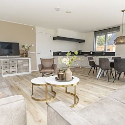 Modern open kitchen and dining area in Villa 21A, De Koog, Texel, ideal vacation home on the Wadden Islands.