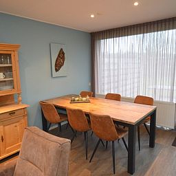 Epelaan 19, De Koog, Texel, has a stylish dining room with wooden furniture.
