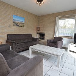 Cozy living room in Holiday home Stappeland 207, De Koog, Texel with comfortable sofas and lots of natural light.