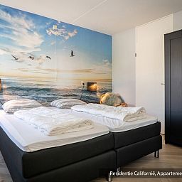 Bedroom in Type 1 vacation home, De Koog, Texel with double bed and beach mural.