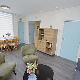 Spacious living room in Plevierstraat 18 vacation home, De Koog, Texel with sitting area and dining area.