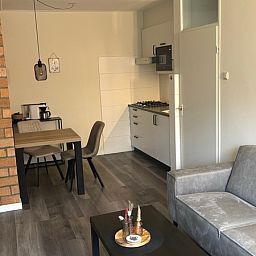 Dining and living space in Apartment Kerckeland 40, De Koog, Texel with open kitchen.