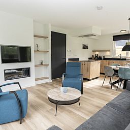 Modern living room of Villa 37, De Koog, Texel. Comfortable seating area in vacation home on the Wadden Islands.