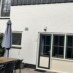 Cozy terrace of Cottage in De Koog on Texel, ideal for relaxing outdoor meals.