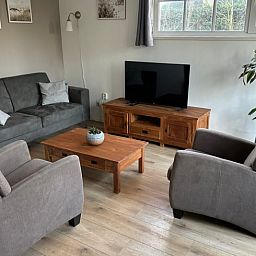 Exterior of vacation home Cottage in De Koog, Texel, with charming bricks and modern windows.