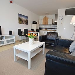 Stylish interior space of Apartment Kerckeland 98, De Koog, Texel with dining and sitting area for a relaxing stay.