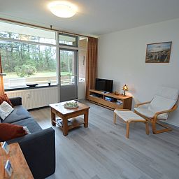 Bright living room of Apartment Kerckeland 20 in De Koog, Texel overlooking the green surroundings.