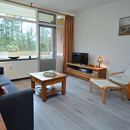 Spacious living room in Apartment Kerckeland 20, De Koog, Texel with modern furnishings and views of nature.
