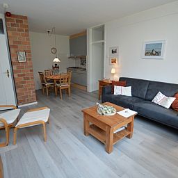 Open living room and kitchen in Apartment Kerckeland 20, De Koog, Texel with cozy atmosphere.