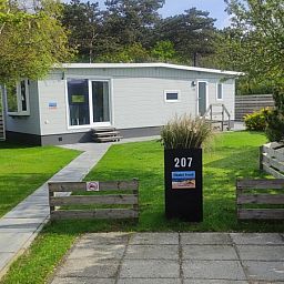 Eingang zum Chalet Bregkoog 207 in De Koog, Texel, umgeben von Natur.