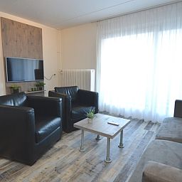 Modern sitting area with television in Motel Texel - Apartment 211/1P, De Koog, Texel.