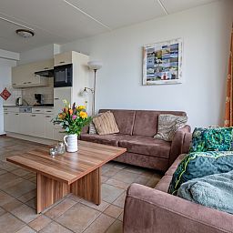 Modern kitchen and sitting area in Resort De Buteriggel Apartment 1, vacation home in De Koog, Texel.