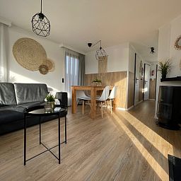 Stilvolles Wohnzimmer im Chalet Bregkoog 253, De Koog, Texel mit moderner Einrichtung und viel natuerlichem Licht.