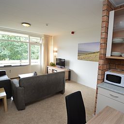 Bright living space of Apartment Kerckeland 122 in De Koog, Texel with comfortable seating.