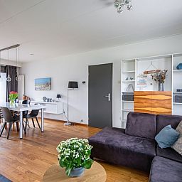 Dining area and comfortable sitting area in Orchismient 55 vacation home De Koog Texel.