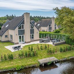 Cozy vacation home Honeysuckle 67 in De Koog Texel with beautiful views of green surroundings and waterfront on the Wadden Islands.