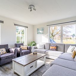 Light and spacious living room in Holiday home Kamperfoelie 67 De Koog Texel overlooking the nature of the Wadden Islands.