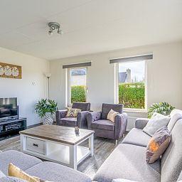 Vacation home Honeysuckle 67 in De Koog Texel with stylish living room and large windows for panoramic views of the Wadden Islands.