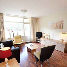 Bright living room of Apartment Kerckeland 24, De Koog, Texel with views of nature and modern furniture.