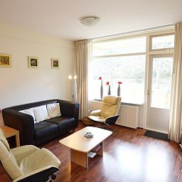 Spacious sitting area in Apartment Kerckeland 24, De Koog, Texel with large windows and lots of natural light.
