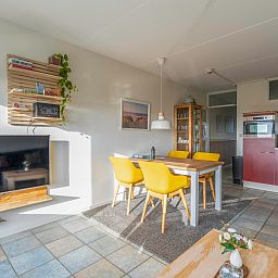 Dining area with yellow chairs in Apartment Juliana 142 Island and Sea View, De Koog Texel.