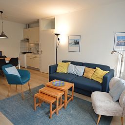 Modern open kitchen in Apartment Kerckeland 126, De Koog, Texel, with dining area and comfortable seating area.