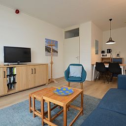 Cozy sitting area in Apartment Kerckeland 126, De Koog, Texel, with television and stylish furnishings.