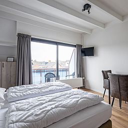 Spacious bedroom with balcony in Two person studio - second floor, De Koog, Texel for a relaxing stay.