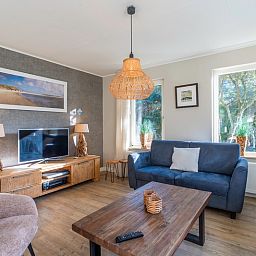 Cozy living room in Holiday Home Honeysuckle 57, De Koog, Texel with comfortable seating area and natural light.